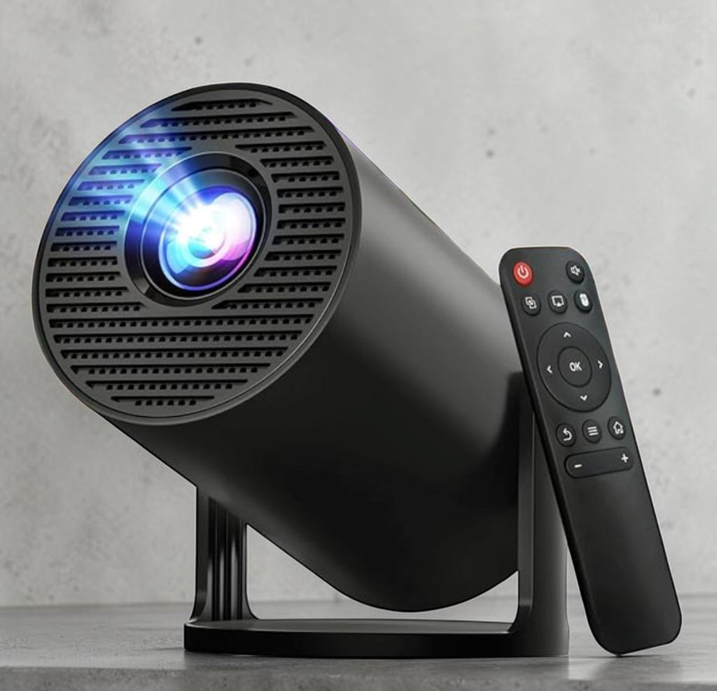 Black projector with remote control on a gray surface
